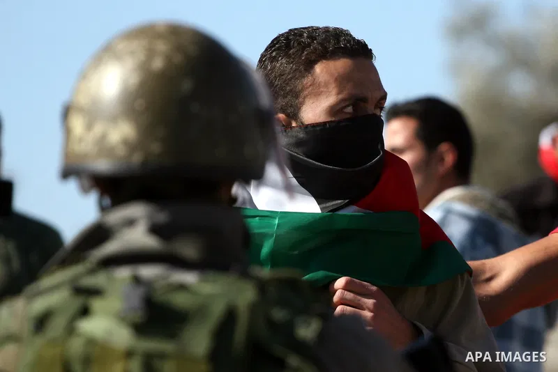 Palestinian protesters take part in a demonstration against the expansion of the nearby Jewish settlement of Halamish in the West Bank village of Nabi Saleh, near Ramallah, Friday, Jan. 21, 2011. Photo by Issam Rimawi