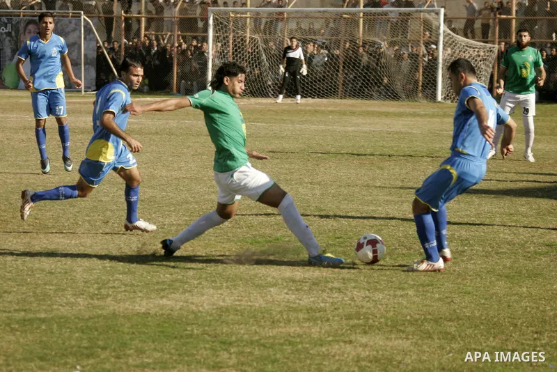 Players from Rafah Youth Club play against the players from Rafah Services Club during a football match in the league of the Gaza Strip at Rafah Municipality Stadium in the southern Gaza Strip on January 21, 2011. Photo...