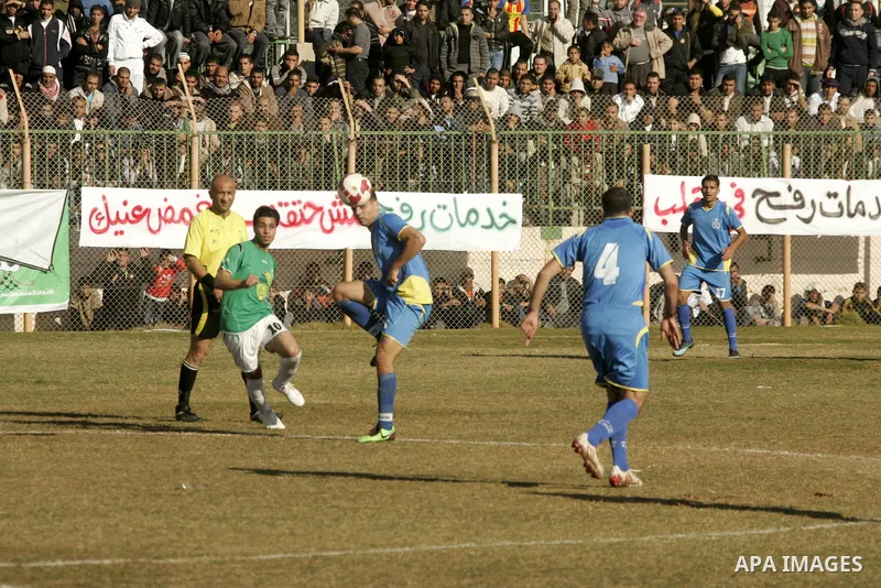 Players from Rafah Youth Club play against the players from Rafah Services Club during a football match in the league of the Gaza Strip at Rafah Municipality Stadium in the southern Gaza Strip on January 21, 2011. Photo...
