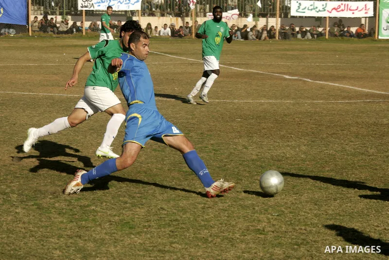 Players from Rafah Youth Club play against the players from Rafah Services Club during a football match in the league of the Gaza Strip at Rafah Municipality Stadium in the southern Gaza Strip on January 21, 2011. Photo...