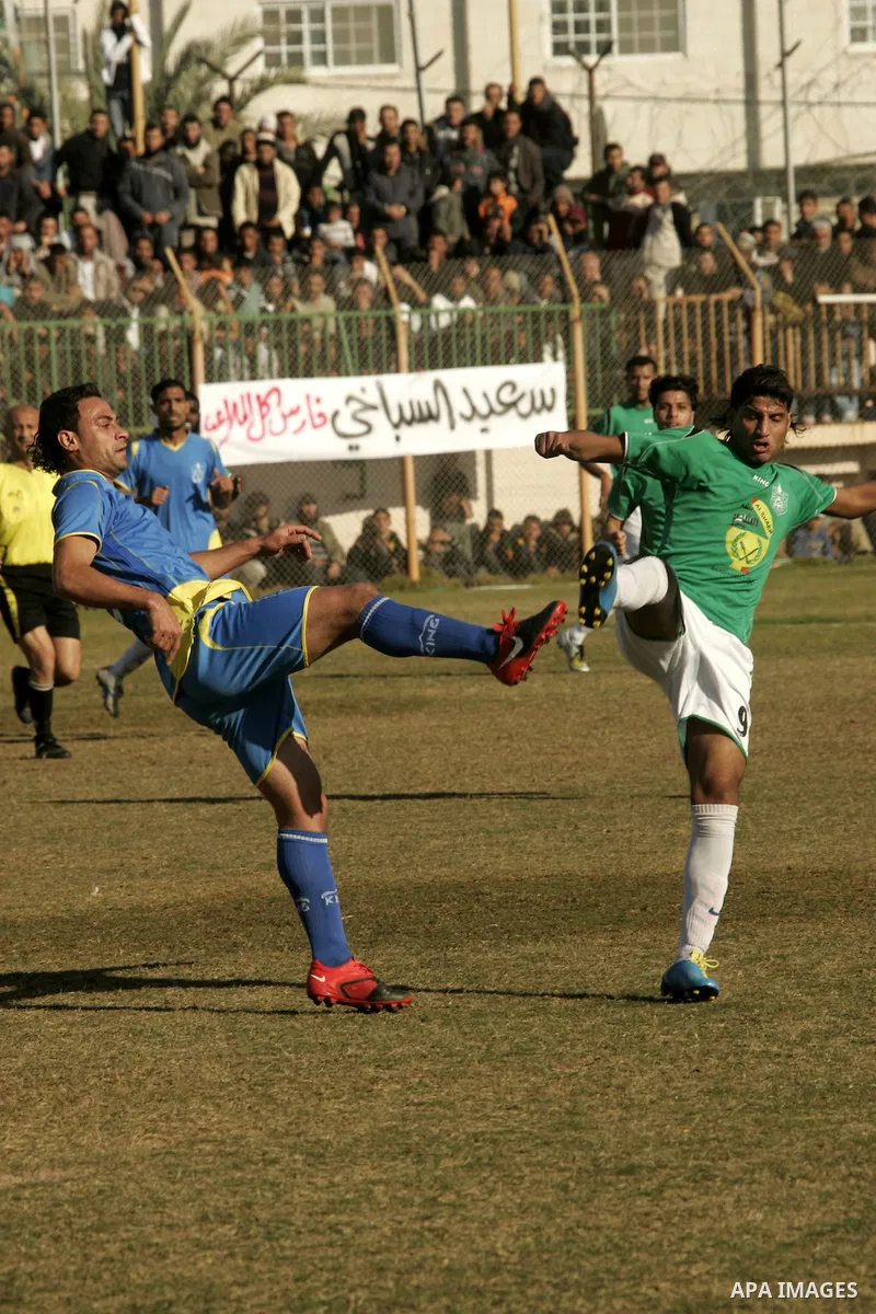 Players from Rafah Youth Club play against the players from Rafah Services Club during a football match in the league of the Gaza Strip at Rafah Municipality Stadium in the southern Gaza Strip on January 21, 2011. Photo...