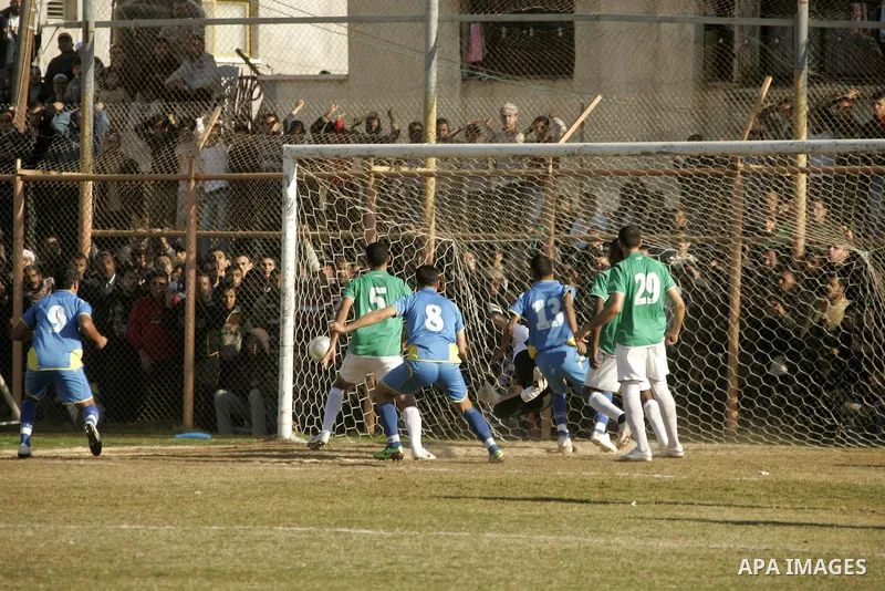 Players from Rafah Youth Club play against the players from Rafah Services Club during a football match in the league of the Gaza Strip at Rafah Municipality Stadium in the southern Gaza Strip on January 21, 2011. Photo...