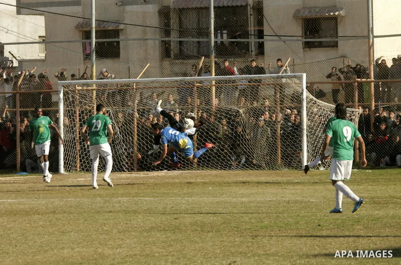Players from Rafah Youth Club play against the players from Rafah Services Club during a football match in the league of the Gaza Strip at Rafah Municipality Stadium in the southern Gaza Strip on January 21, 2011. Photo...