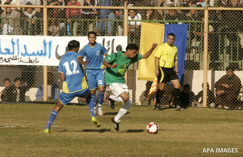 Players from Rafah Youth Club play against the players from Rafah Services Club during a football match in the league of the Gaza Strip at Rafah Municipality Stadium in the southern Gaza Strip on January 21, 2011. Photo...