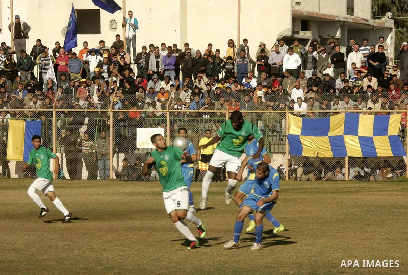 Players from Rafah Youth Club play against the players from Rafah Services Club during a football match in the league of the Gaza Strip at Rafah Municipality Stadium in the southern Gaza Strip on January 21, 2011. Photo...