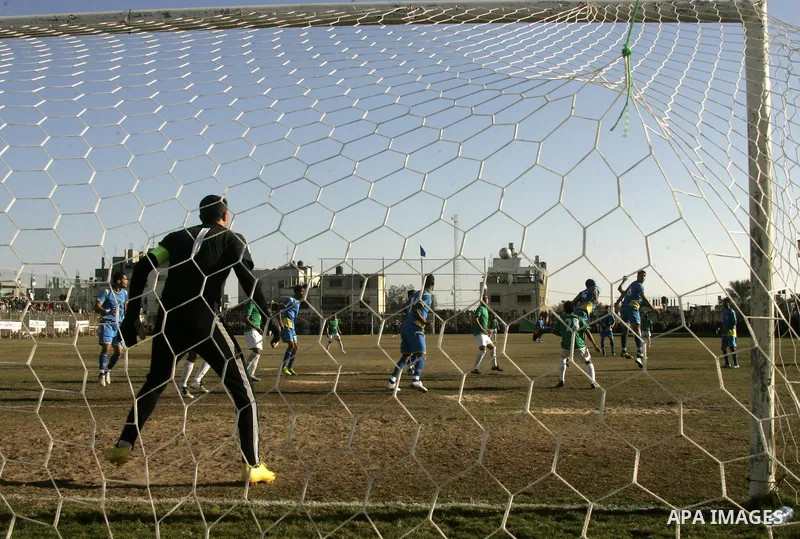 Players from Rafah Youth Club play against the players from Rafah Services Club during a football match in the league of the Gaza Strip at Rafah Municipality Stadium in the southern Gaza Strip on January 21, 2011. Photo...