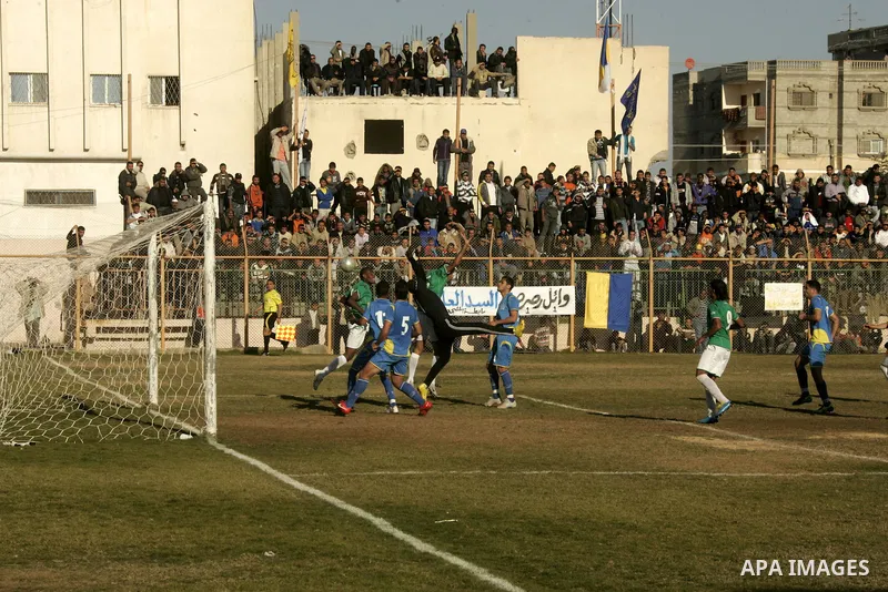 Players from Rafah Youth Club play against the players from Rafah Services Club during a football match in the league of the Gaza Strip at Rafah Municipality Stadium in the southern Gaza Strip on January 21, 2011. Photo...