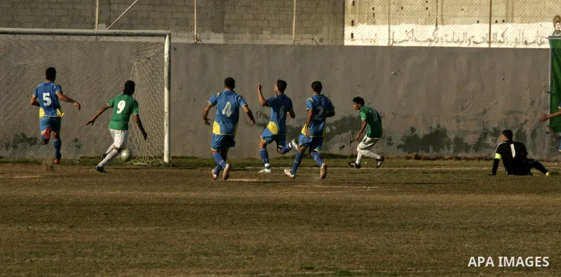 Players from Rafah Youth Club play against the players from Rafah Services Club during a football match in the league of the Gaza Strip at Rafah Municipality Stadium in the southern Gaza Strip on January 21, 2011. Photo...