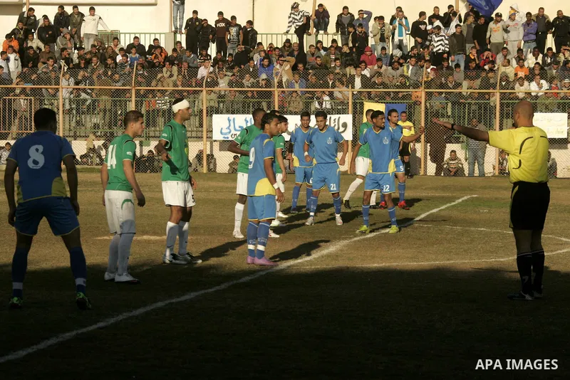 Players from Rafah Youth Club play against the players from Rafah Services Club during a football match in the league of the Gaza Strip at Rafah Municipality Stadium in the southern Gaza Strip on January 21, 2011. Photo...