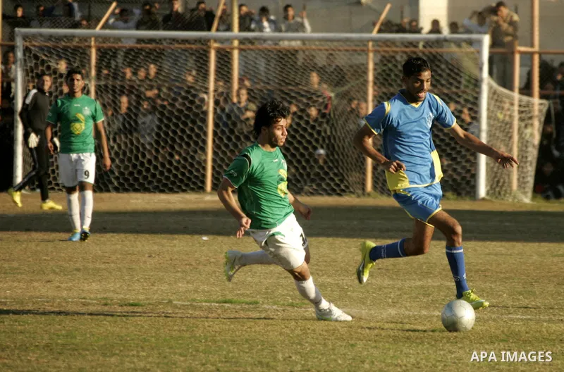 Players from Rafah Youth Club play against the players from Rafah Services Club during a football match in the league of the Gaza Strip at Rafah Municipality Stadium in the southern Gaza Strip on January 21, 2011. Photo...