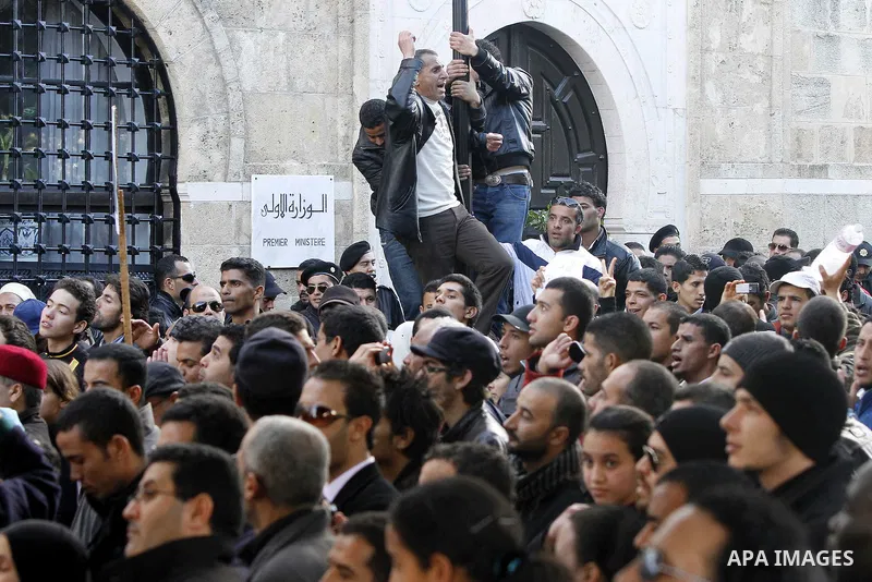 Protestors shout slogans in front of the Prime Minister's office in Tunis, Friday, Jan. 21 2011. Several hundred demonstrators also gathered peacefully across from the long-dreaded Interior Ministry in central Tunis, cha...