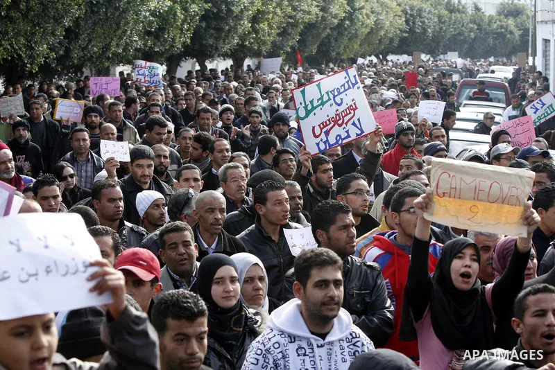Protestors shout slogans in front of the Prime Minister's office in Tunis, Friday, Jan. 21 2011. Several hundred demonstrators also gathered peacefully across from the long-dreaded Interior Ministry in central Tunis, cha...