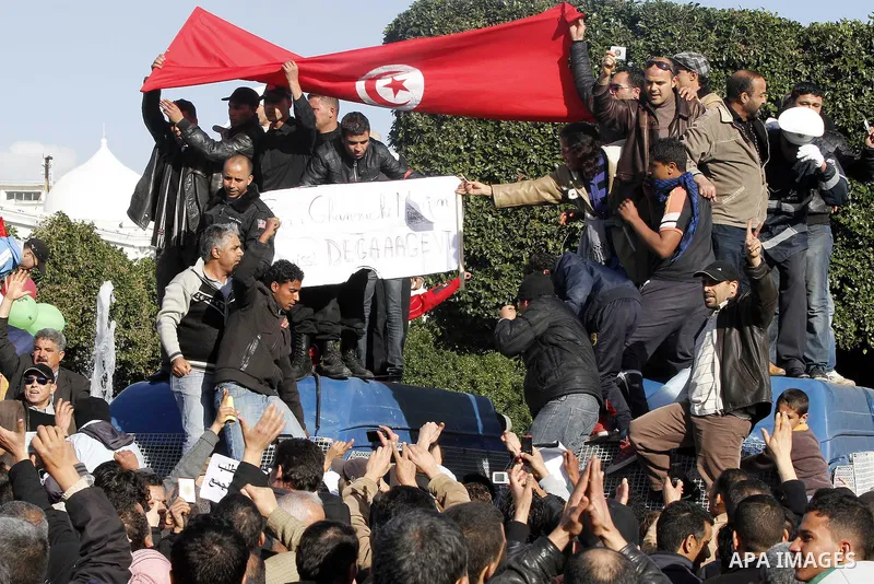 Protestors shout slogans in front of the Prime Minister's office in Tunis, Friday, Jan. 21 2011. Several hundred demonstrators also gathered peacefully across from the long-dreaded Interior Ministry in central Tunis, cha...