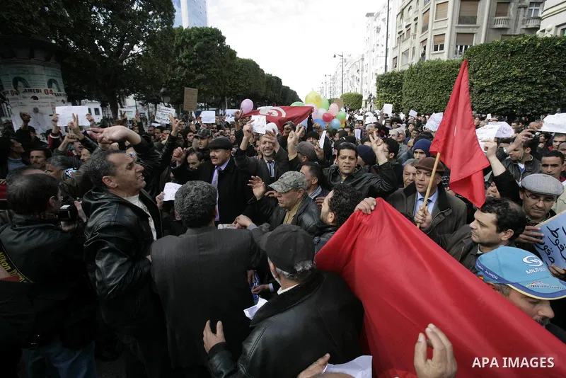 Protestors shout slogans in front of the Prime Minister's office in Tunis, Friday, Jan. 21 2011. Several hundred demonstrators also gathered peacefully across from the long-dreaded Interior Ministry in central Tunis, cha...