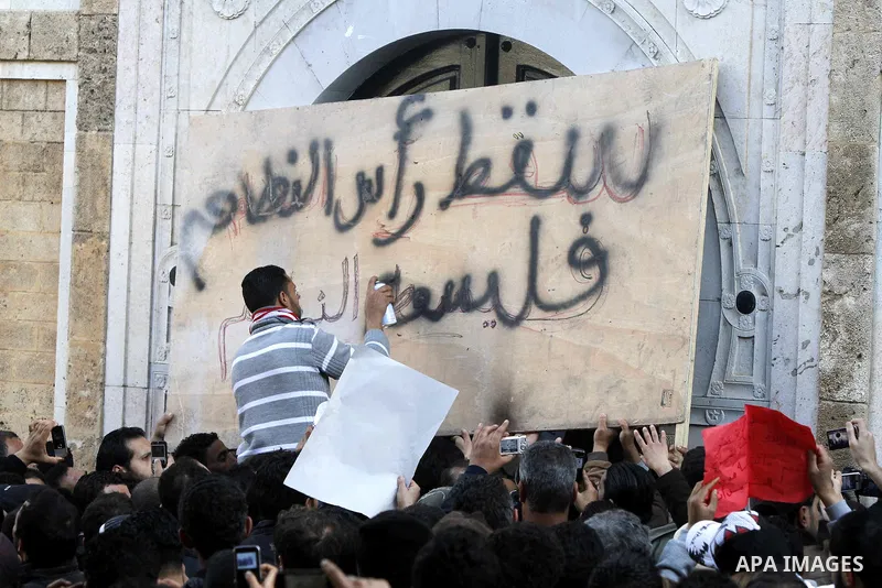 Protestors shout slogans in front of the Prime Minister's office in Tunis, Friday, Jan. 21 2011. Several hundred demonstrators also gathered peacefully across from the long-dreaded Interior Ministry in central Tunis, cha...