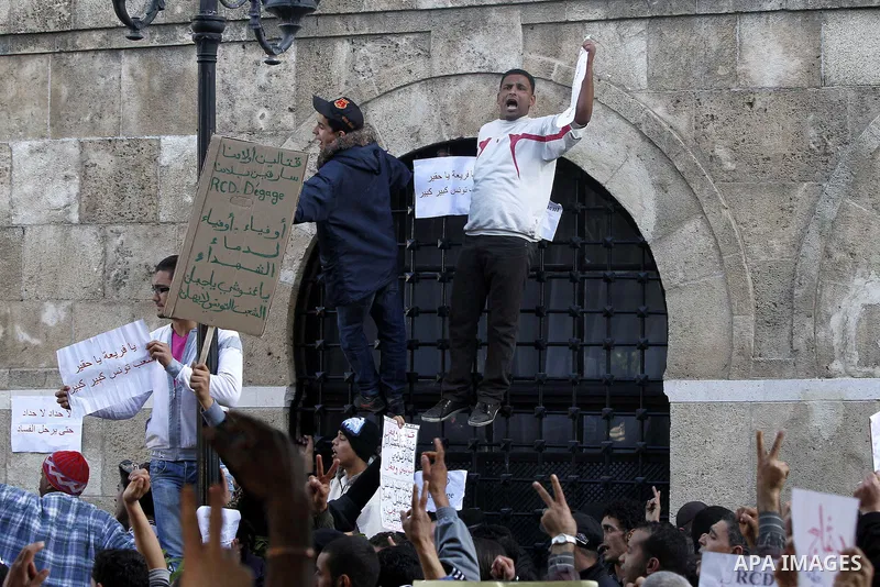 Protestors shout slogans in front of the Prime Minister's office in Tunis, Friday, Jan. 21 2011. Several hundred demonstrators also gathered peacefully across from the long-dreaded Interior Ministry in central Tunis, cha...