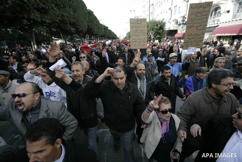 Protestors shout slogans in front of the Prime Minister's office in Tunis, Friday, Jan. 21 2011. Several hundred demonstrators also gathered peacefully across from the long-dreaded Interior Ministry in central Tunis, cha...