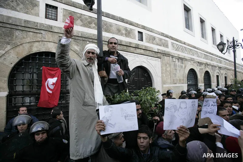 Protestors shout slogans in front of the Prime Minister's office in Tunis, Friday, Jan. 21 2011. Several hundred demonstrators also gathered peacefully across from the long-dreaded Interior Ministry in central Tunis, cha...