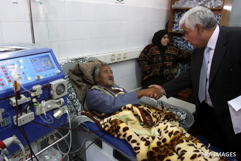 A member of the Libyan convoy " Al-Quds 5 " shake hands with a Palestinian patient during their visit to Al-Shifa Hospital, in Gaza City on Jan. 22, 2011. Photo by Mohammed Asad