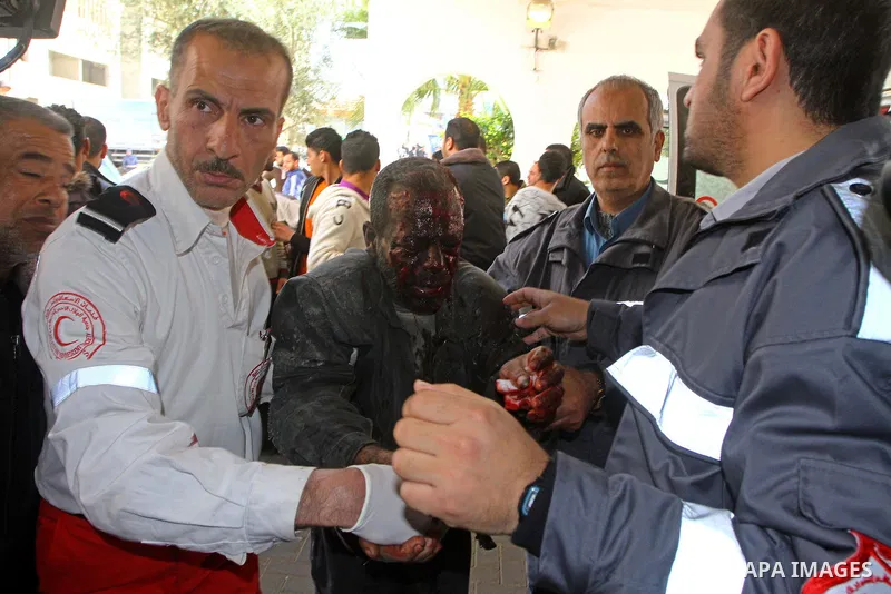Palestinian paramedics help a wounded man walk into Al-Shifa hospital in Gaza City, Jan. 22, 2011. A Palestinian was killed and three were wounded Saturday when a leftover ordnance from previous Israeli shelling exploded...