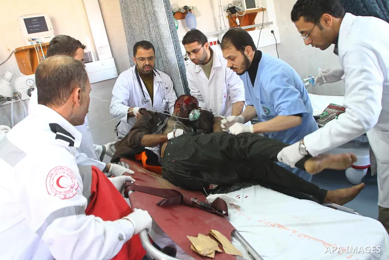 A wounded Palestinian youth receives a treatment at al-Shifa hospital in Gaza City, Jan. 22, 2011. A Palestinian was killed and three were wounded Saturday when a leftover ordnance from previous Israeli shelling exploded...
