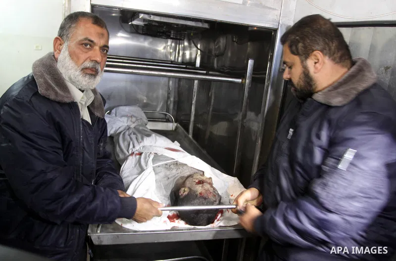 Palestinian security officers look at the body of Ahmed Abu Wadi, 22, at the morgue of al-Shifa hospital in Gaza City on Jan. 22, 2011. Ahmed Abu Wadi was killed and two were wounded Saturday when a leftover ordnance fro...