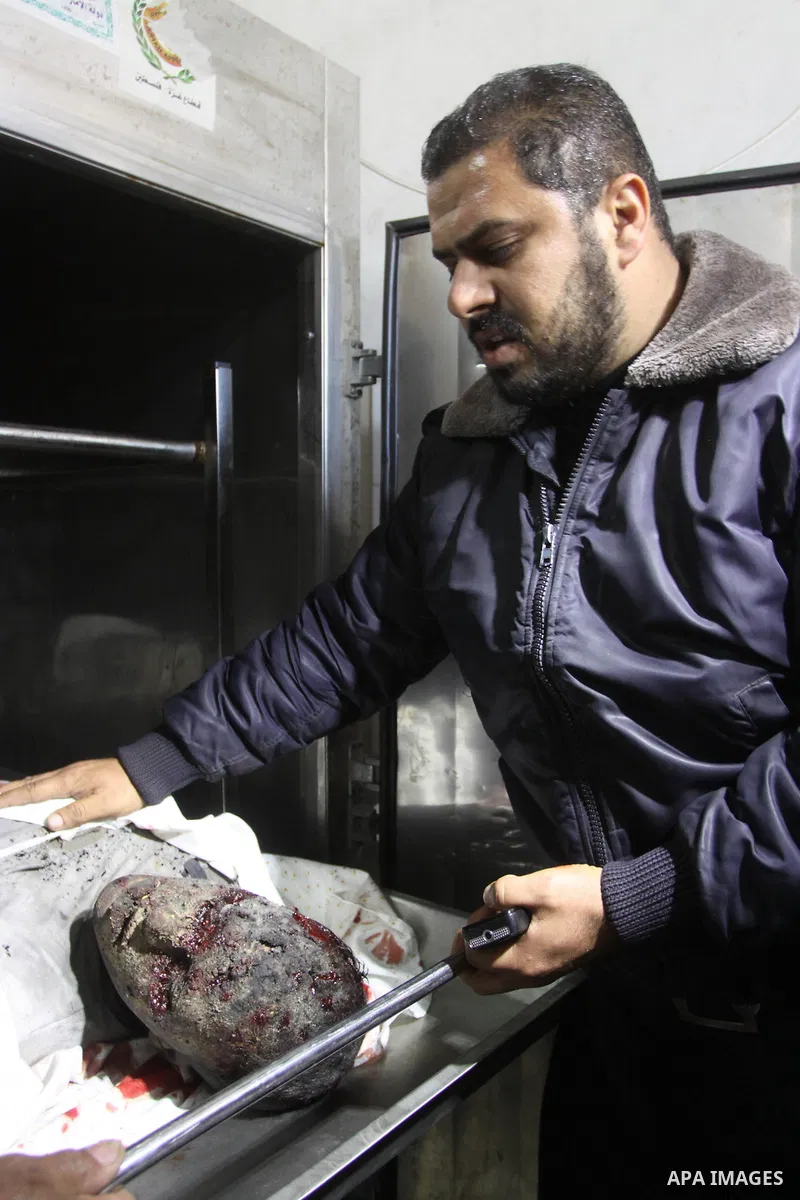 A Palestinian security officers looks at the body of Ahmed Abu Wadi , 22, at the morgue of al-Shifa hospital in Gaza City on Jan. 22, 2011. Ahmed Abu Wadi was killed and two were wounded Saturday when a leftover ordnance...