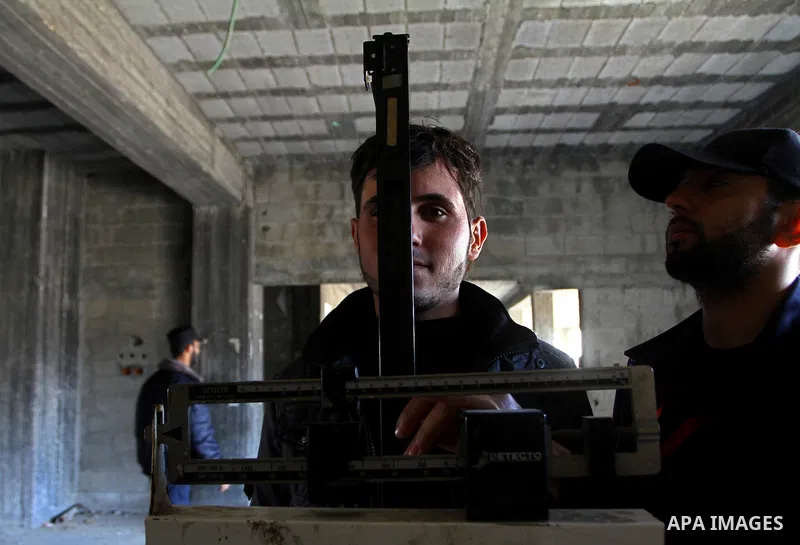 A young Palestinian man is measured at a Hamas police recruitment center in Gaza City on January 22, 2011. Photo by Ashraf Amra