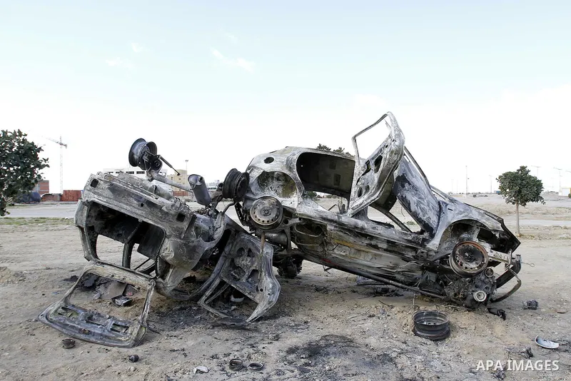 Burned cars are seen on a street in Carthage, outside Tunis, January 22, 2011.A Tunisian prosecutor opened an investigation into the overseas assets of the ousted president and his deeply resented family Wednesday, as th...