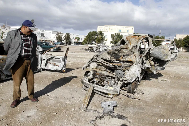 Burned cars are seen on a street in Carthage, outside Tunis, January 22, 2011.A Tunisian prosecutor opened an investigation into the overseas assets of the ousted president and his deeply resented family Wednesday, as th...