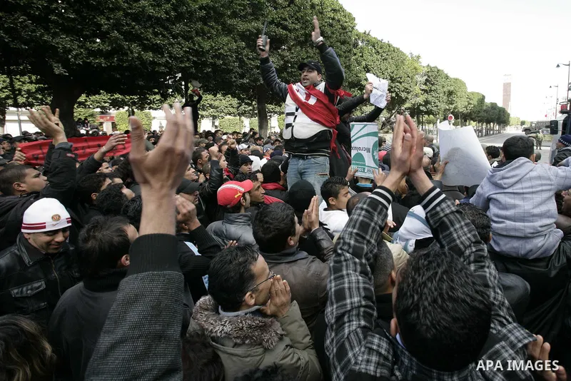 A Tunisian policeman takes part in a gathering of protesters, amongst them policemen, who ask for the right to form unions, and better salaries outside the Government Palace inTunis, Tunisia, 22 January 2011. Tunisians b...