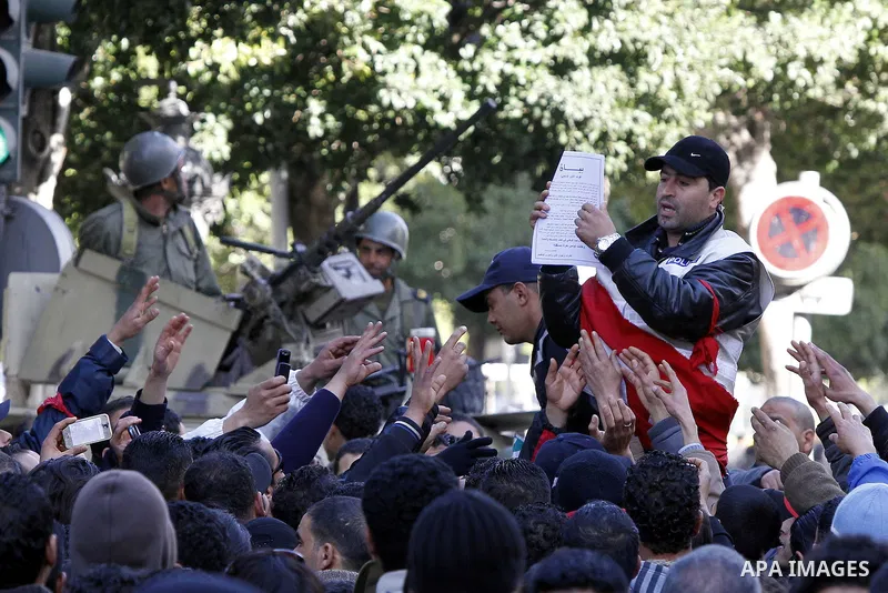 A Tunisian policeman takes part in a gathering of protesters, amongst them policemen, who ask for the right to form unions, and better salaries outside the Government Palace inTunis, Tunisia, 22 January 2011. Tunisians b...