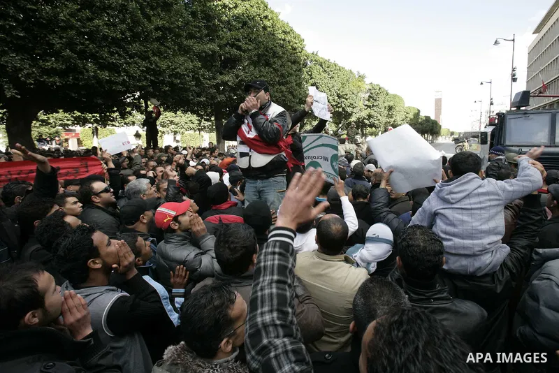 A Tunisian policeman takes part in a gathering of protesters, amongst them policemen, who ask for the right to form unions, and better salaries outside the Government Palace inTunis, Tunisia, 22 January 2011. Tunisians b...