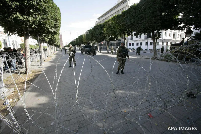 Tunisian policemen take part in a gathering of protesters, amongst them policemen, who ask for the right to form unions, and better salaries outside the Government Palace inTunis, Tunisia, 22 January 2011. Tunisians bega...