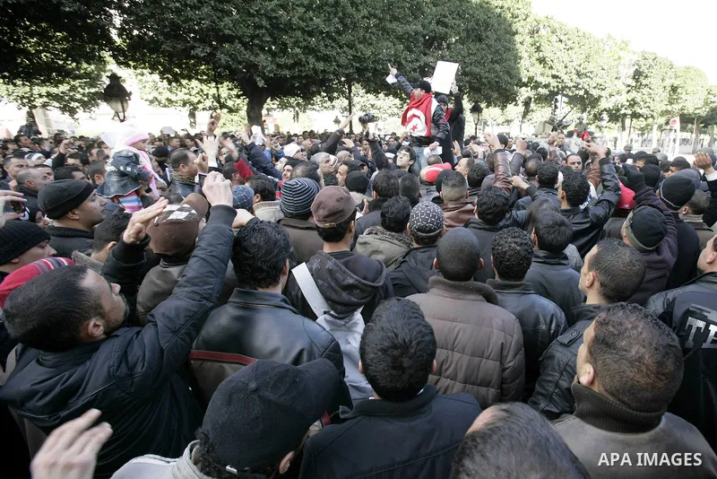 A Tunisian policeman takes part in a gathering of protesters, amongst them policemen, who ask for the right to form unions, and better salaries outside the Government Palace inTunis, Tunisia, 22 January 2011. Tunisians b...