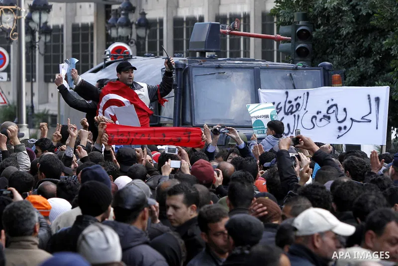 A Tunisian policeman takes part in a gathering of protesters, amongst them policemen, who ask for the right to form unions, and better salaries outside the Government Palace inTunis, Tunisia, 22 January 2011. Tunisians b...