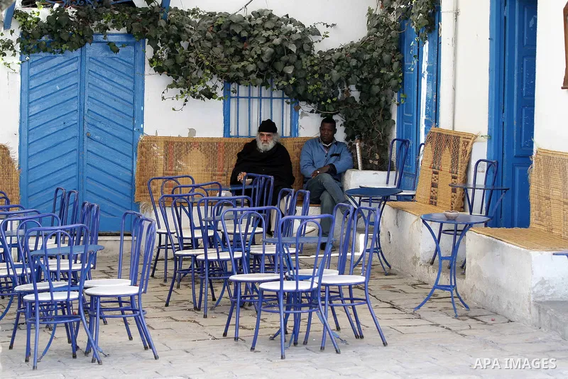 Tunisian sit in empty Cafe in Carthage, outside Tunis, January 22, 2011.A Tunisian prosecutor opened an investigation into the overseas assets of the ousted president and his deeply resented family Wednesday, as the U.N....