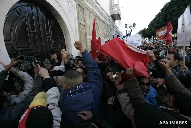 Tunisians hold placards during a demonstration to demand a new government free of officials of the ousted regime of former president Zine el Abidine Ben Ali, goes on in central Tunis, Tunisia, 23 January 2011. According...
