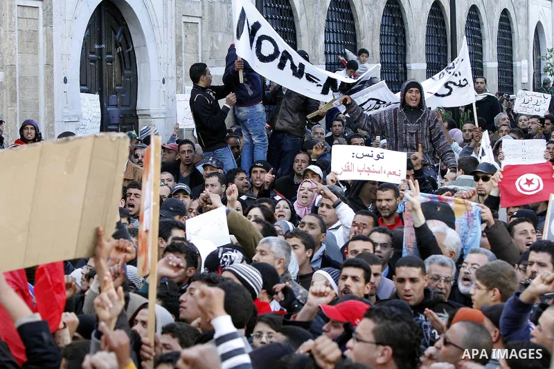 Tunisians hold placards during a demonstration to demand a new government free of officials of the ousted regime of former president Zine el Abidine Ben Ali, goes on in central Tunis, Tunisia, 23 January 2011. According...