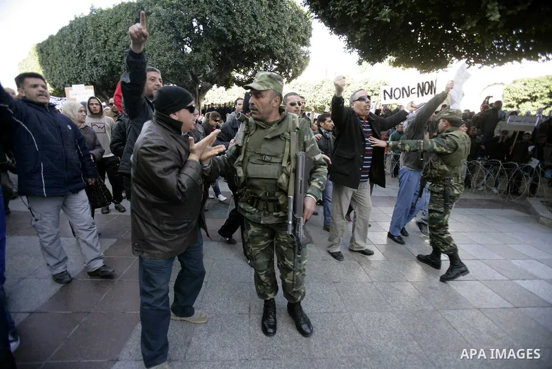 Tunisians hold placards during a demonstration to demand a new government free of officials of the ousted regime of former president Zine el Abidine Ben Ali, goes on in central Tunis, Tunisia, 23 January 2011. According...
