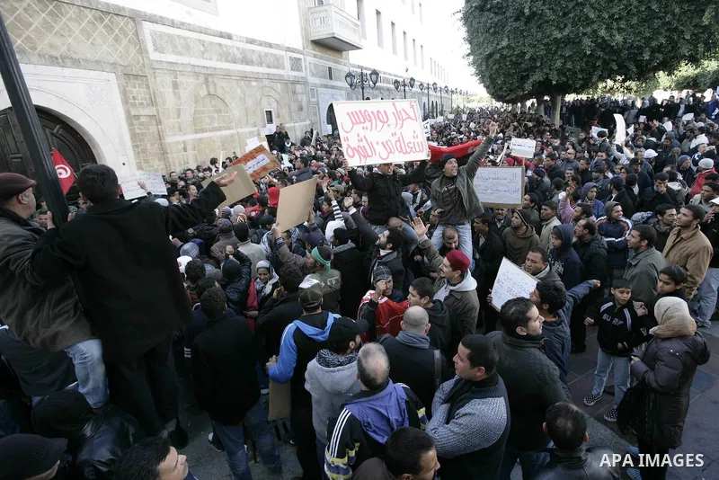 Tunisians hold placards during a demonstration to demand a new government free of officials of the ousted regime of former president Zine el Abidine Ben Ali, goes on in central Tunis, Tunisia, 23 January 2011. According...