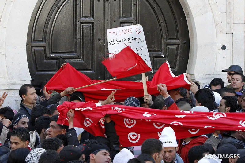 Tunisians hold placards during a demonstration to demand a new government free of officials of the ousted regime of former president Zine el Abidine Ben Ali, goes on in central Tunis, Tunisia, 23 January 2011. According...