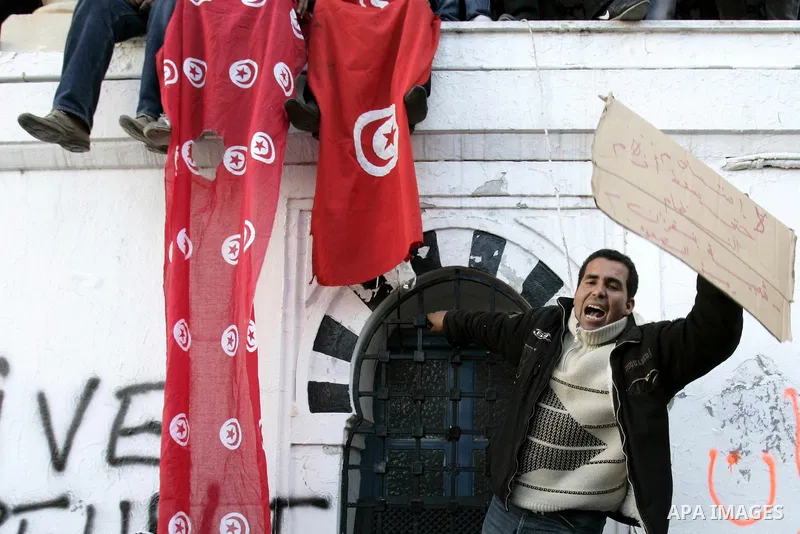 Tunisians hold placards during a demonstration to demand a new government free of officials of the ousted regime of former president Zine el Abidine Ben Ali, goes on in central Tunis, Tunisia, 23 January 2011. According...