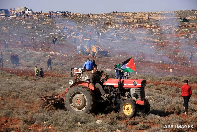 Israeli soldiers fire tear gas canisters at Palestinian farmers as they plant trees during a protest against the uprooting of trees belonging to palestinians over farming land between the Jewish settlement Shiloh and the...