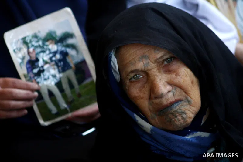 Palestinian women and children hold pictures of jailed relatives during a protest calling for the release of Palestinian prisoners from Israeli jails at the Red Cross office in Gaza City on Jan. 24, 2011. Photo by Ashraf...