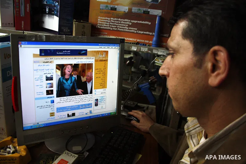 A Palestinian man go on the internet in his shop in the West Bank city of Hebron on 24 January 2011 concerning the 1,600 secret documents published by Al-Jazeera about the Israeli Palestinian negotiations. Palestinian of...
