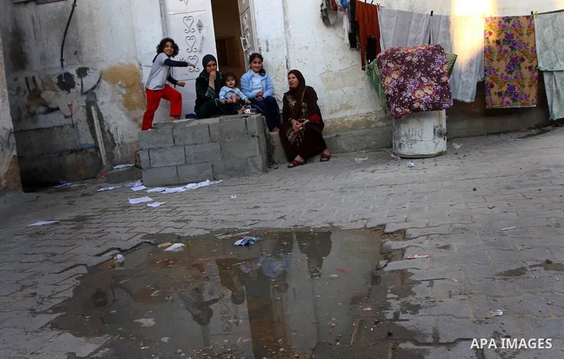 Palestinian refugees sit in front of their home in the Jabalia refugee camp in the northern Gaza Strip on January 24, 2011 a day after leaked documents were published by Al-Jazeera and the British newspaper the Guardian,...