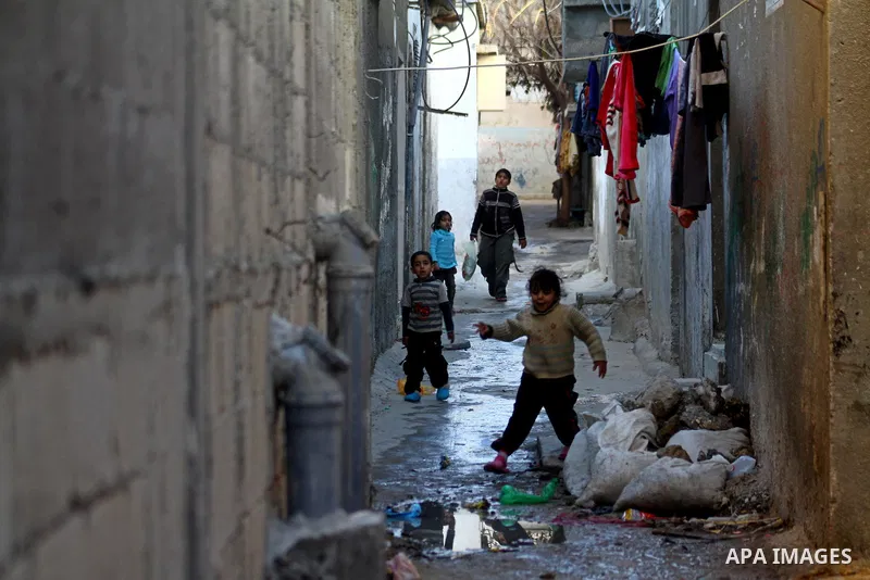 Palestinian refugee children play in front of their home in the Jabalia refugee camp in the northern Gaza Strip on January 24, 2011 a day after leaked documents were published by Al-Jazeera and the British newspaper the...