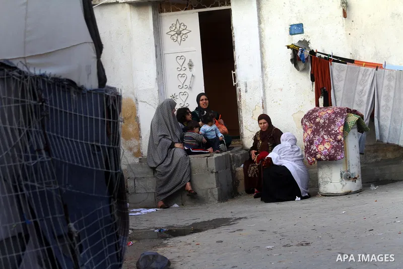 Palestinian refugees sit in front of their home in the Jabalia refugee camp in the northern Gaza Strip on January 24, 2011 a day after leaked documents were published by Al-Jazeera and the British newspaper the Guardian,...