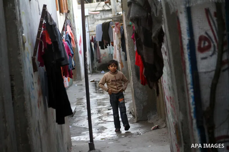 A Palestinian refugee boy walks in front of his home in the Jabalia refugee camp in the northern Gaza Strip on January 24, 2011 a day after leaked documents were published by Al-Jazeera and the British newspaper the Guar...